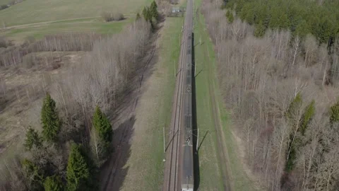 Passenger Train Going Through spring fields and Forest, Aerial View. Stock Footage 193515747