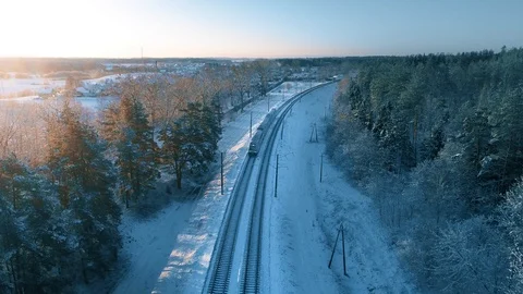 Passenger Train Going Through Winter Snowy Forest, Aerial View Stock Footage 105349125