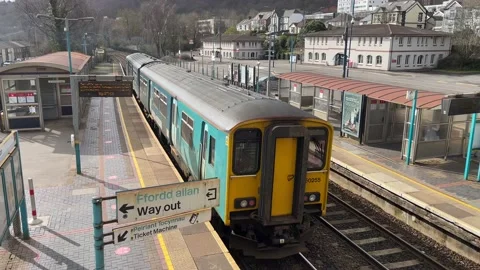 Passenger train leaving station in South Wales Stock Footage 150332001