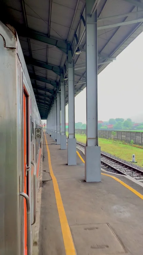 Passenger Train at Modern Railway Platform During Rainy Day Stock Footage 337690266