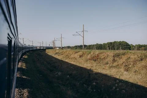 Passenger train moves fast at sunset time. Stock-Fotos