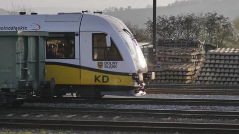 A passenger train moving from behind the wagons Stock Footage 244710112
