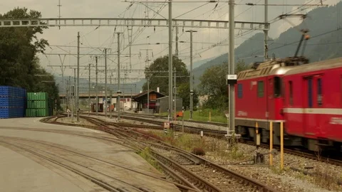 Passenger train passes camera leaving village Stock Footage 86757120