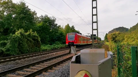 A passenger train passes a level crossing with closed gates Video stock 256500645