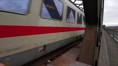 A passenger train passes a metal bridge Stock Footage 256500607