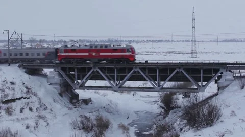 Passenger Train passes over bridge in winter Video stock 59942673