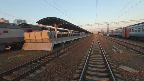 A passenger train passes by a railway platform 스톡 동영상 229528947