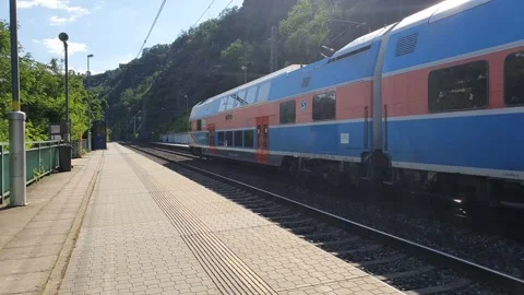 A passenger train passes the station in the mountains. Video stock 167069563