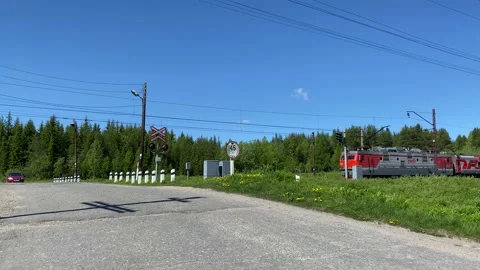 Passenger train passes through the crossing. 4K shooting Stock Footage 132567575