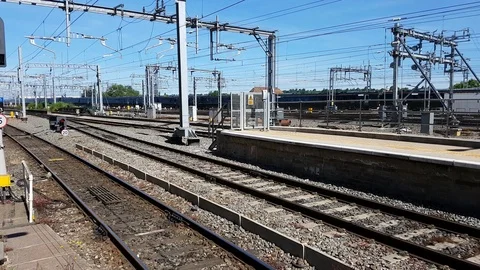 A passenger train passes through a station in England, 4K Stock Footage 111132386