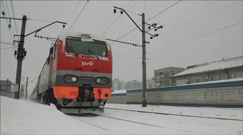Passenger Train passing by closely lifting snow dust Stock Footage 36064847