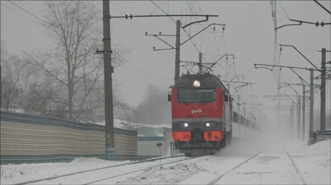 Passenger Train passing by closely lifting snow dust 2 Stock Footage 36065033