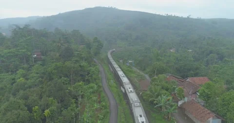 Passenger Train Passing by a Curved Rail Near Cikubang Bridge and Cipularang Stock Footage 131099258
