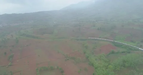 Passenger Train Passing Curves Rail and Cutting Rock Near Citiis Bridge Stock Footage 131087801
