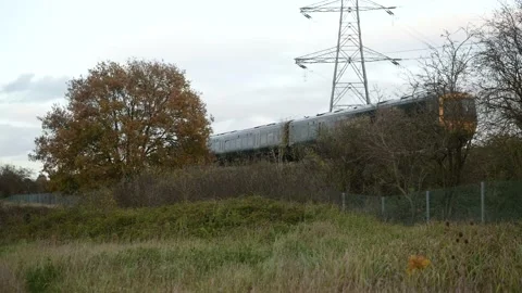 Passenger train passing on elevated embankment Stock Footage 143921380