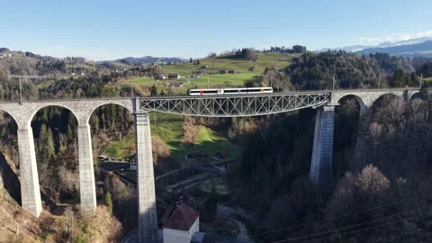 Passenger Train Passing High Viaduct Side Level Aerial Shot 스톡 동영상 330082826