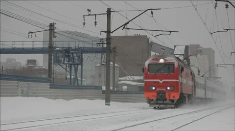 Passenger Train passing by lifting snow dust Stock Footage 36064903