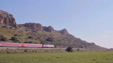 Passenger train passing through a beautiful countryside cliffs landscape 1 Stock-Footage 46011547