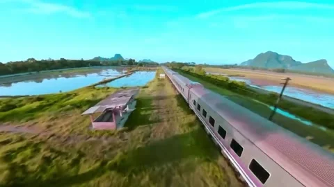 A passenger train passing through beautiful open natural scenery. 스톡 동영상 329200508
