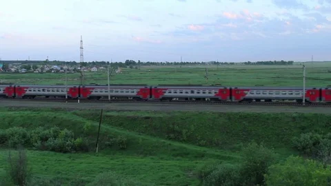 Passenger train passing through the fields in the countryside Stock Footage 76498679