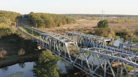 Passenger train passing through the railway bridge. Aerial drone view. Stock Footage 232389465