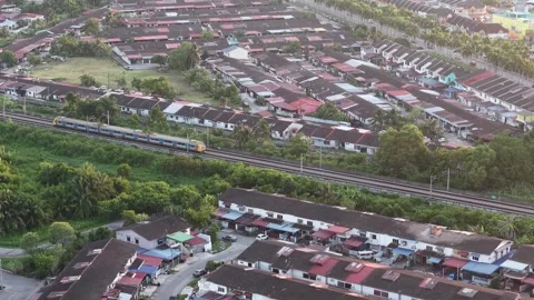 A passenger train passing through rows of suburban terrace houses Stock-Footage 332091963