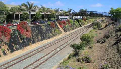 Passenger Train passing through small valley and under bridge 스톡 동영상 11139242
