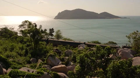 Passenger train rides between huge stones along the sea Video stock 236087182