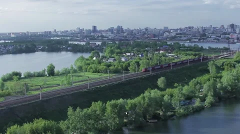 Passenger train rides on city background summer Stock Footage 63614050