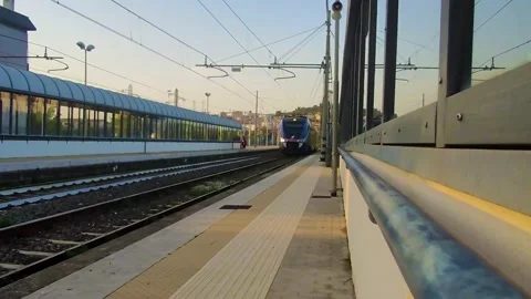 Passenger Train Rides on the Railroad. A Train Arrives at a Train Station. Stock Footage 231575137