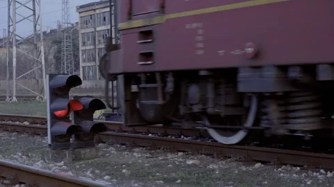 Passenger train with several carriages and a red traffic light Stock Footage 302065174