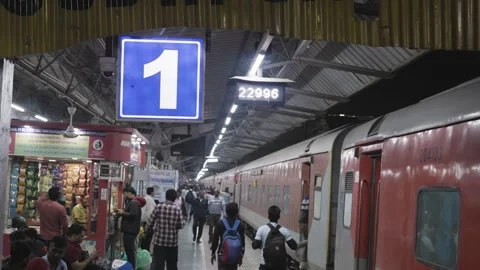 Passenger train standing at platform no one with passenger boarding at evenin Stock Footage 285300927
