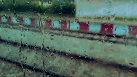 Passenger Train Through Rain Covered Glass Window 動画素材 347989266