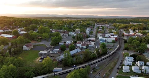 Passenger train through town of Orange @ sunset Stock Footage 272373061