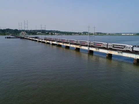 Passenger train traveling between Perth Amboy and South Amboy, New Jersey Video stock 77880678