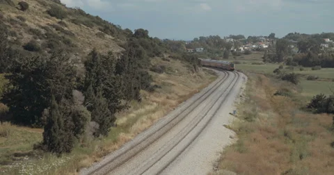 Passenger train travelling from a high angle at Israel Stock Footage 62262763