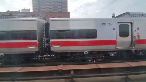 Passenger Train travelling through Harlem, New York City - tracking shot Stock Footage 118997786