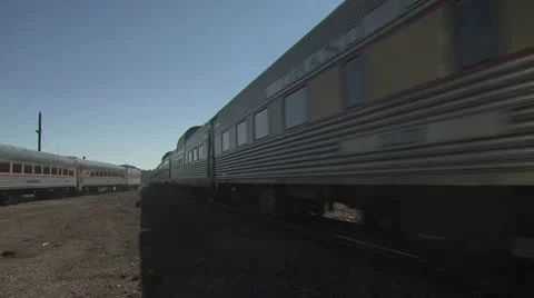 A Passenger Train Travels Down The Track Alongside a Stopped Train Video stock 19049474