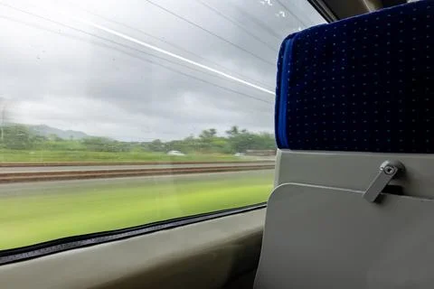 Passenger Train Window View During Daytime with motion blur Photos