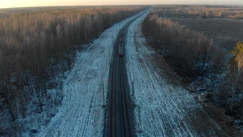 Passenger train in the winter forest in the evening. The picturesque landscape Stock Footage 129723433