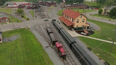 Passenger Trains pull in and out of a station, as a coal train passes. People Vidéo 331701464