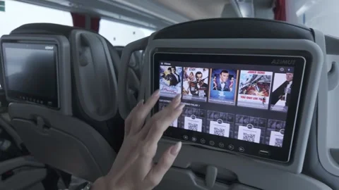 Passenger Uses Touchscreen Entertainment Display, Comfortable Winter Bus Journey Stock Footage 336339361