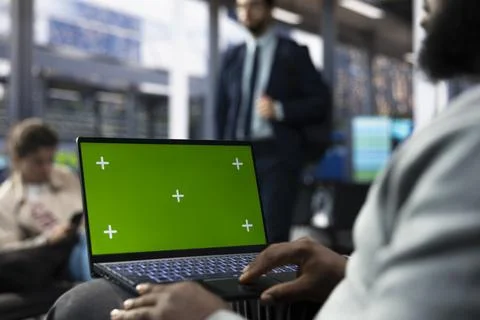 Passenger using green screen laptop in bus station while waiting Stock Photos