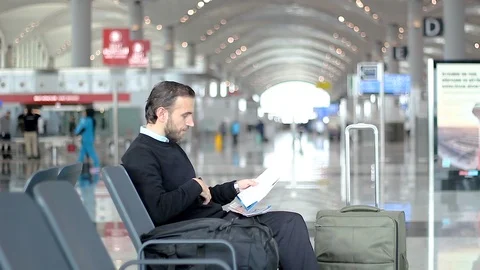 Passenger is using phone app looking at boarding pass at the airport 動画素材 99068483