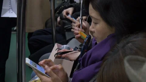 Passenger Using Phone Inside The Tokyo Metro In Tokyo, Japan Stock Footage 159057042