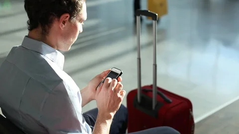 Passenger using wi-fi free access on smartphone in airport Stock Footage 96140809