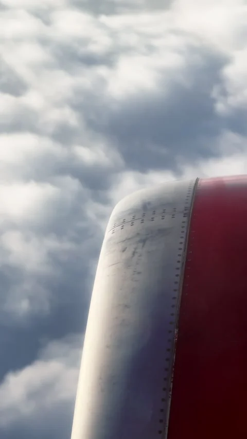 Passenger vertically shoots video on phone of the engine of flying plane and Stock Footage 293809660