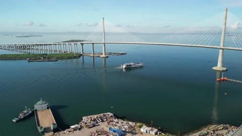 Passenger vessel passing underneath bridge, Cebu City, Philippines Stock-Footage 199908733