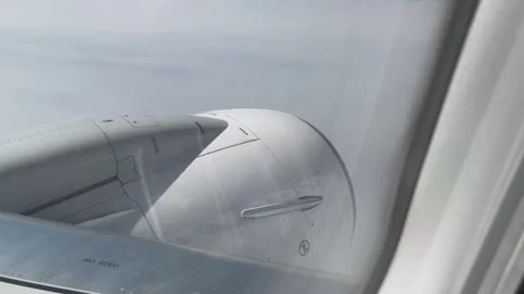 Passenger view from airplane window looking at jet engine while flying high.. Stock Footage 337605924