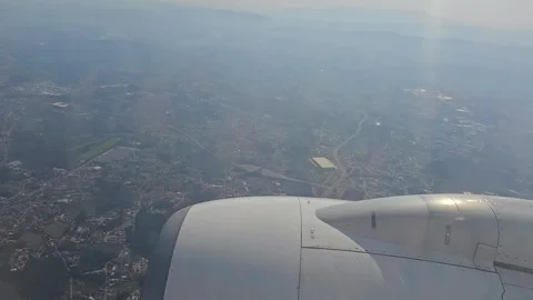 Passenger views wing during flight over city Stock Footage 344374789